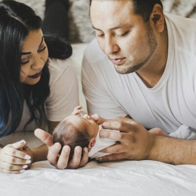 A loving family shares a tender moment with their newborn baby at home.