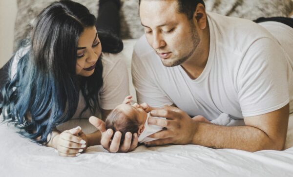 A loving family shares a tender moment with their newborn baby at home.